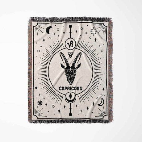 A vertical shot of the Capricorn Zodiac Blanket, showcasing the detailed Capricorn symbol and starry design. This intricately woven throw is an exceptional birthday gift idea for astrology enthusiasts and can be used as a tapestry or cozy throw blanket.