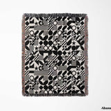 Black and white classical checker board pattern woven blanket throw flat lay on a white background.