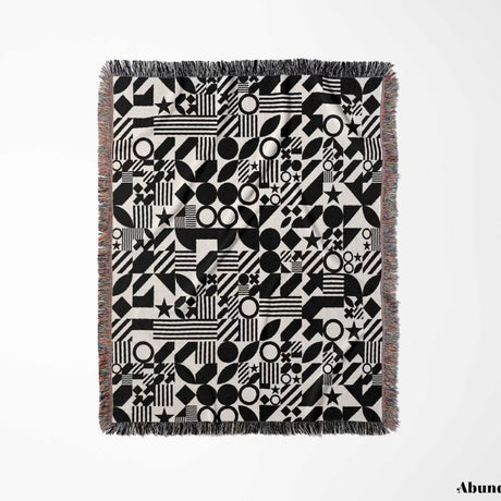 Black and white classical checker board pattern woven blanket throw flat lay on a white background.