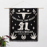 Cow skull and boots 2nd anniversary gift woven throw blanket with cowboy-themed design and personalized text on a white wall as a wall art.