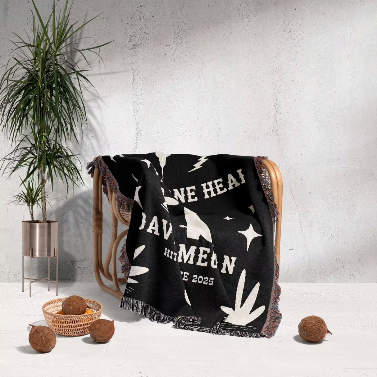 Cow skull and boots 2nd anniversary gift woven throw blanket with white text and graphics draped over a chair in a room with a plant and decorative items.
