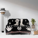 Cow skull and boots 2nd anniversary gift woven throw blanket with white designs draped over a couch in a room with a lamp and plant.