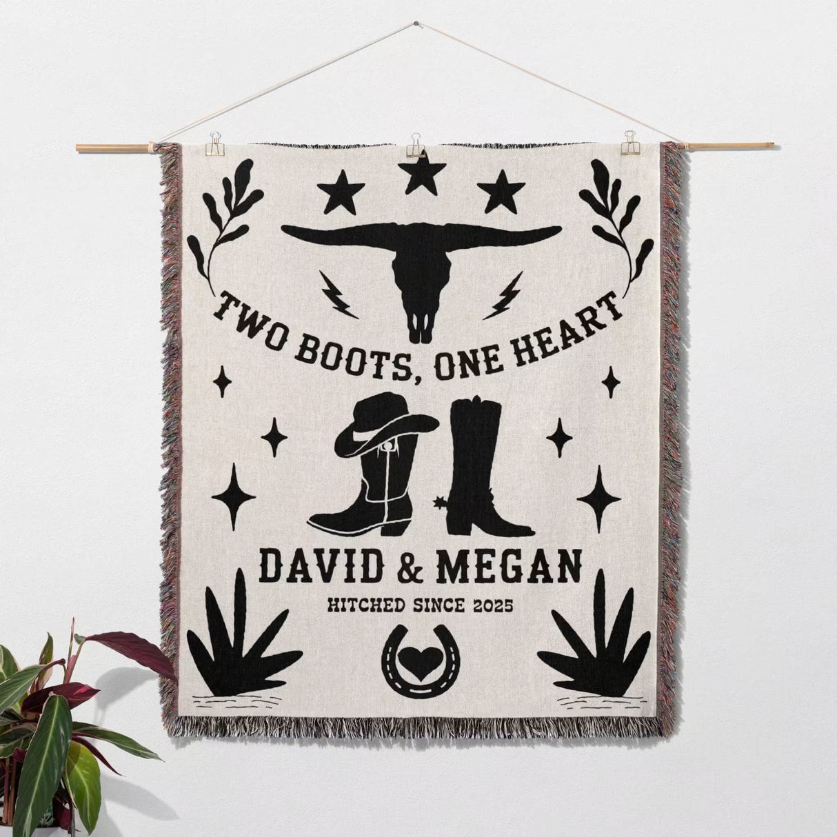 Cow skull and boots cotton anniversary gift woven throw blanket blanket with cowboy-themed design and personalized text, hanging on a wall.