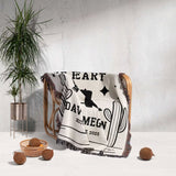 Cowboy boots wedding cotton anniversary gift woven throw blanket with text and graphics draped over a chair against a white wall with a plant and decorative items.