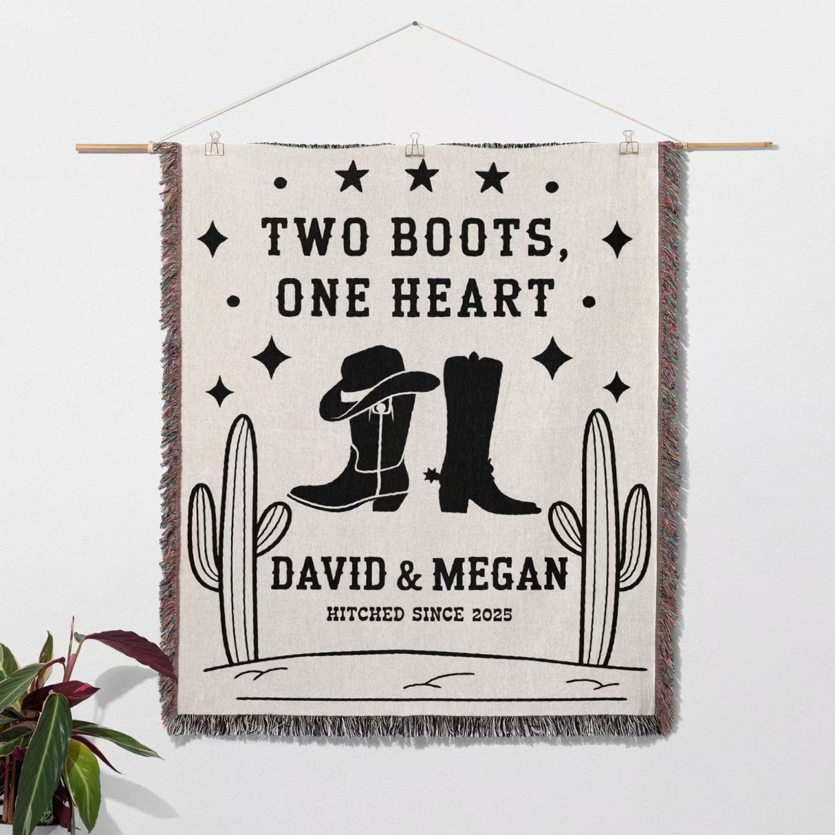 Cowboy boots wedding cotton anniversary gift woven throw blanket as a wall hanging with cowboy boots and cacti design, featuring text 'Two Boots, One Heart' and 'Hitched Since 2023'.