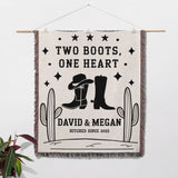 Cowboy boots wedding cotton anniversary gift woven throw blanket as a wall hanging with cowboy boots and cacti design, featuring text 'Two Boots, One Heart' and 'Hitched Since 2023'.