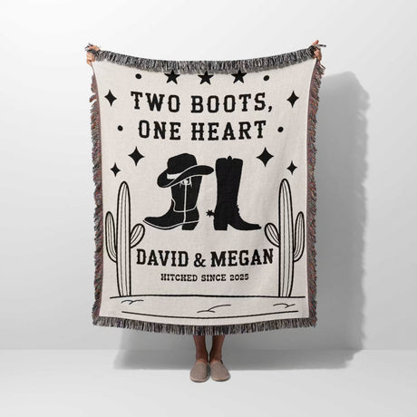 Cowboy boots wedding cotton anniversary gift woven throw blanket held by a person with cowboy boots and text on a white background