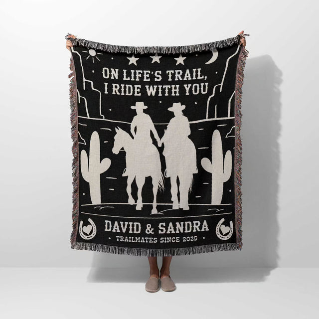 Cowboy and cowgirl 2nd anniversary gift woven throw blanket held by a person with cowboy design and text on a white background