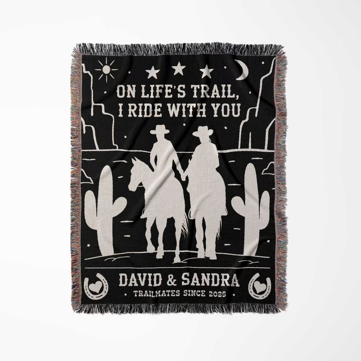 Cowboy and cowgirl 2nd anniversary gift woven throw blanket flat lay with western desert scene design, text, and silhouettes of a couple on a horse.