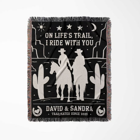 Cowboy and cowgirl 2nd anniversary gift woven throw blanket flat lay with western desert scene design, text, and silhouettes of a couple on a horse.