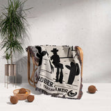 Cowboy and cowgirl cotton anniversary gift woven throw blanket with cowboy design on a chair next to a plant and decorative items.