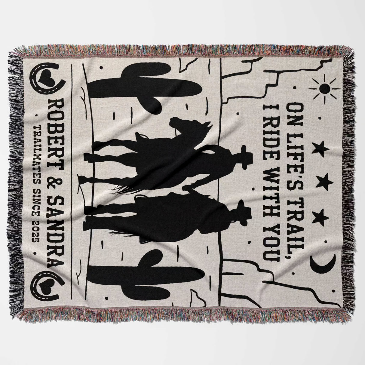 Cowboy and cowgirl cotton anniversary gift woven throw blanket flat lay with cowboy design, text, and fringes on a white background