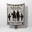 Cowboy and cowgirl cotton anniversary gift woven throw blanket held by a person with cowboy design and text on a white background