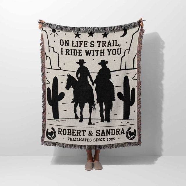 Cowboy and cowgirl cotton anniversary gift woven throw blanket held by a person with cowboy design and text on a white background