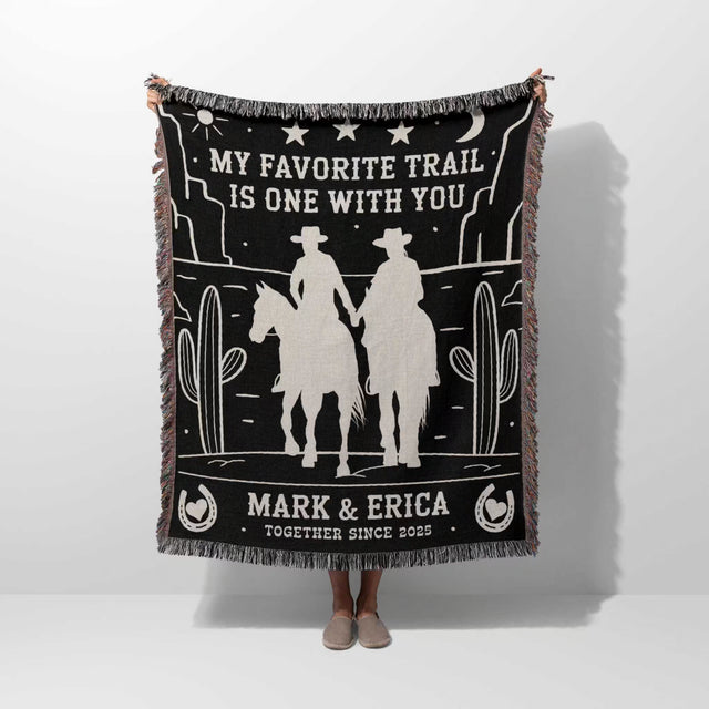 Cowboy and cowgirl couple 2nd anniversary gift woven throw blanket held by a person with cowboy design and text on a white background