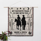 Cowboy and cowgirl couple cotton anniversary gift woven throw blanket with cowboy design and text hanging on a wall as a wall tapestry. 