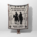 Cowboy and cowgirl couple cotton anniversary gift woven throw blanket with cowboy design and text, held by a person on a white background