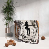 Cowboy and cowgirl western cotton anniversary gift woven throw blanket with a western design and text draped over a chair in a room with a plant and decorative items.