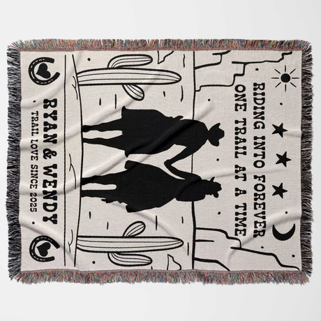 Cowboy and cowgirl western cotton anniversary gift woven throw blanket flat lay with horse design and text on a white background