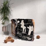 Cowboy and cowgirl on two horses 2nd anniversary gift woven throw blanket with western design draped over a chair in a room with a plant and decorative items.
