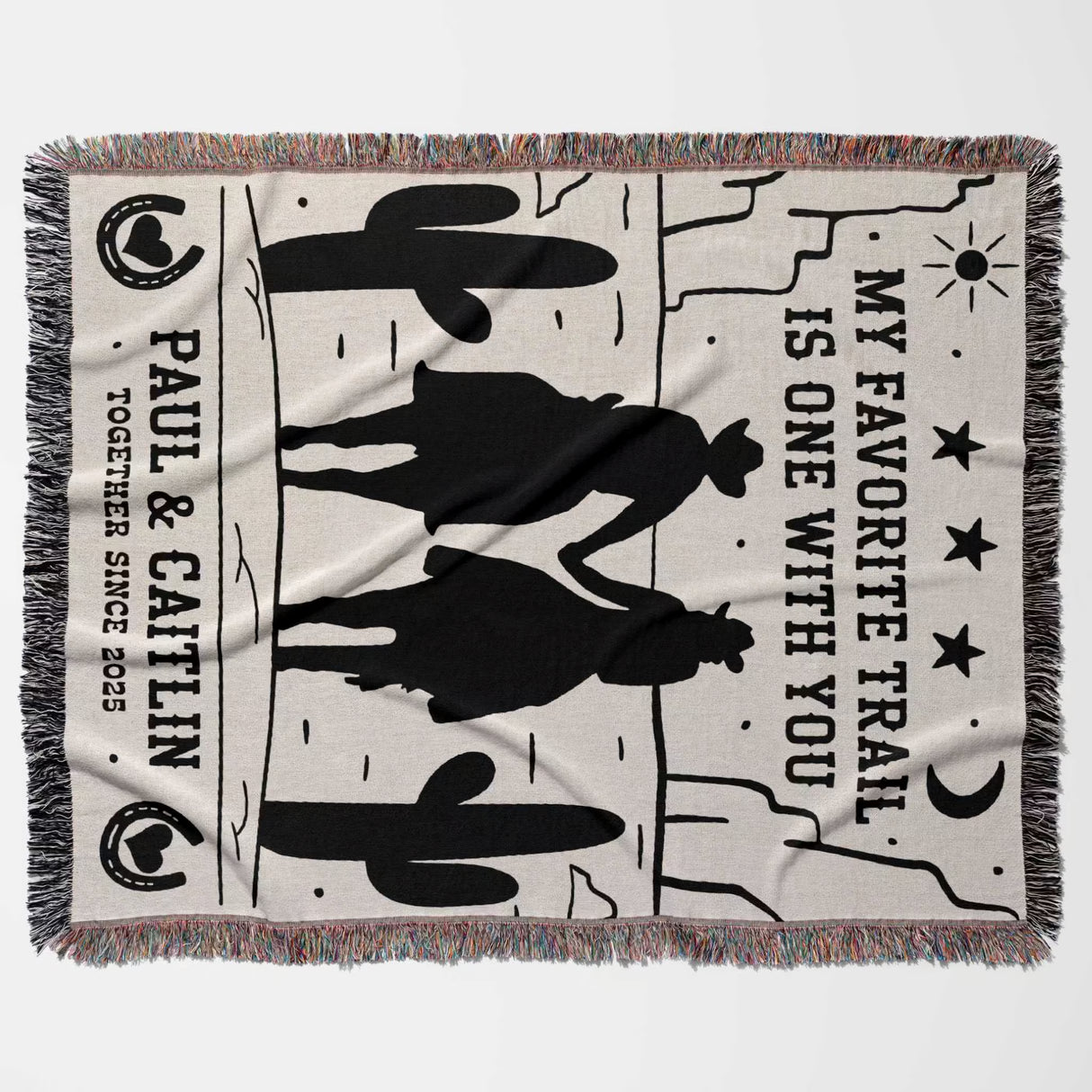 Cowboy and cowgirl on two horses cotton anniversary gift woven throw blanket flat lay with cowboy design and text on a white background