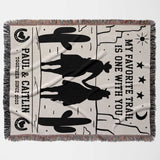 Cowboy and cowgirl on two horses cotton anniversary gift woven throw blanket flat lay with cowboy design and text on a white background
