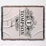 Custom family name blanket with floral design and 'Tompson' text full view on a light background