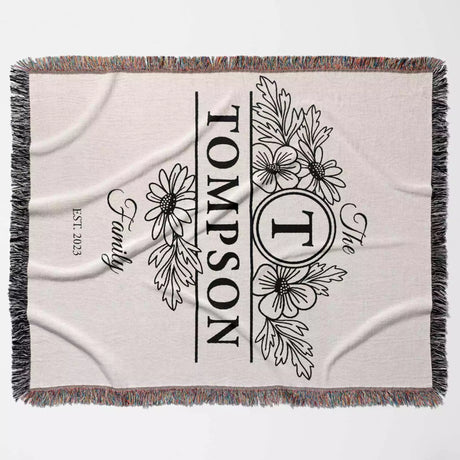 Custom family name blanket with floral design and 'Tompson' text full view on a light background
