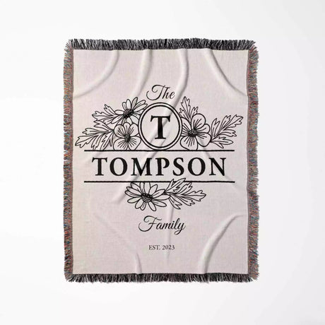 Custom family name blanket with 'The Tompson Family' design flat lay on a white background