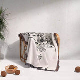 Custom family name blanket with floral design and text draped over a chair on a light background