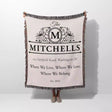 Custom family name and address blanket with 'The Mitchells' design and text held by a person on a white background