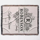 Custom last name cotton blanket with floral design, 'Robinson Family' text, and monogram full view on a light background