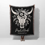 Floral cow skull 2nd anniversary gift woven throw blanket with white bull skull design and custom text held by a person on a white background