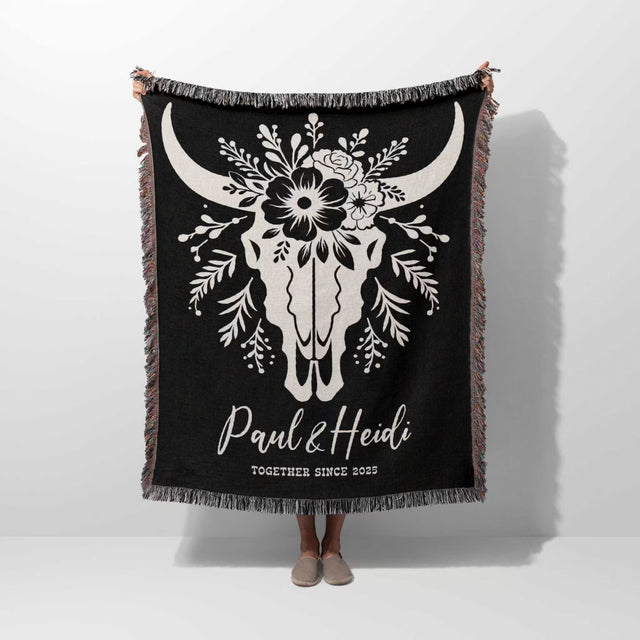 Floral cow skull 2nd anniversary gift woven throw blanket with white bull skull design and custom text held by a person on a white background