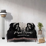 Floral cow skull 2nd anniversary gift woven throw blanket with custom text and designs on a couch in a room with a lamp and plant.