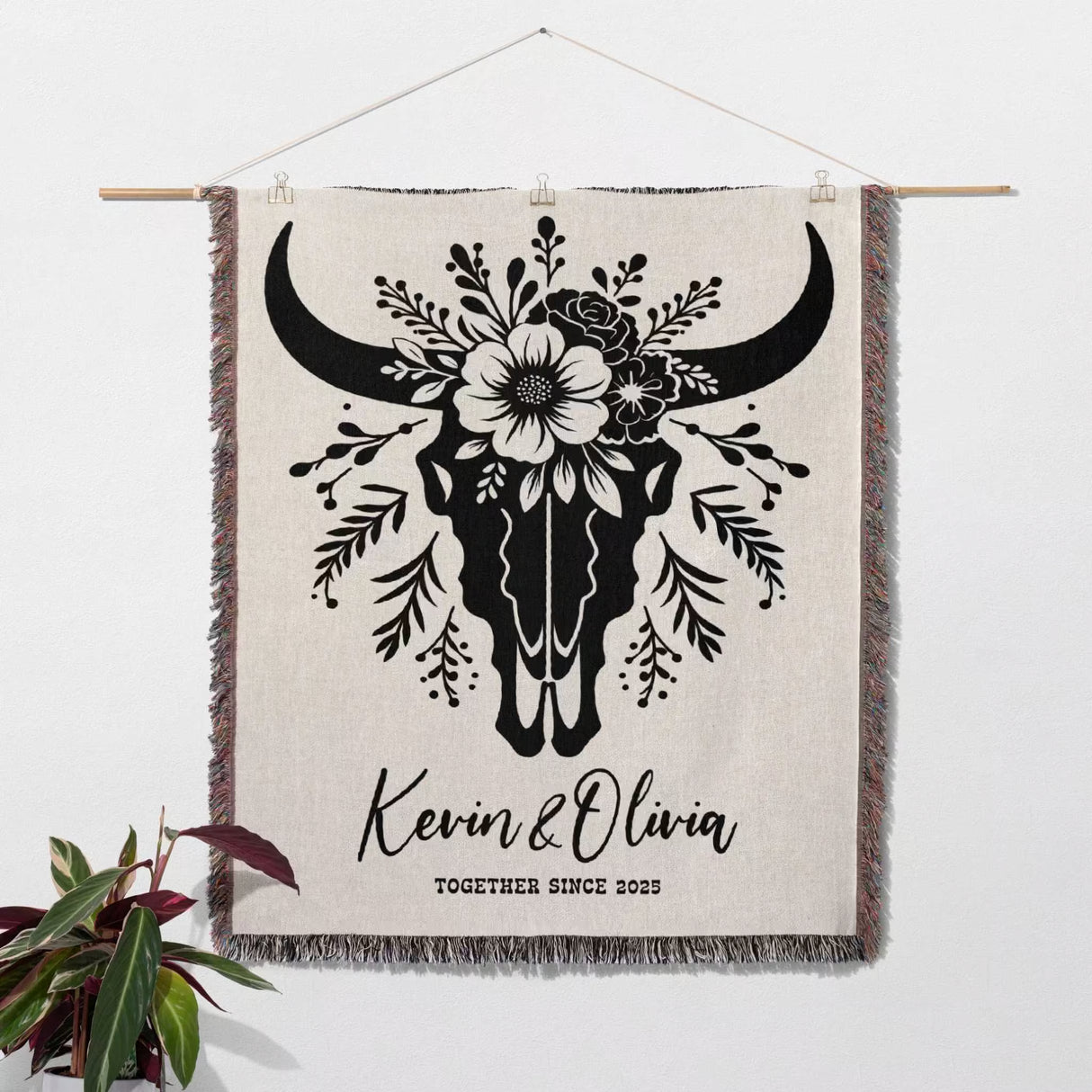 Floral cow skull cotton anniversary gift woven throw blanket as decorative wall hanging with bull skull design and personalized text, featuring a plant on a white background.