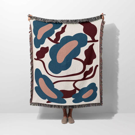 Floral Matisse inspired tapestry throw blanket for couch hold by a person on a white background