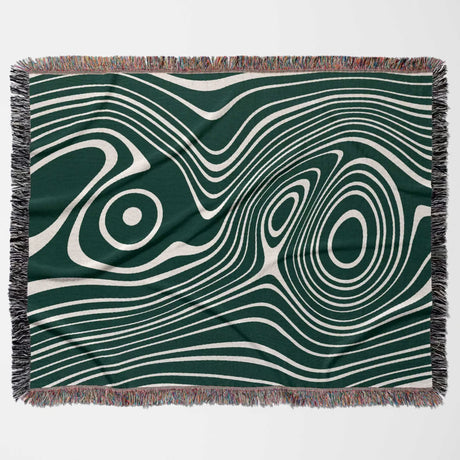 Forest green abstract woven throw blanket with green and white abstract pattern on a plain background
