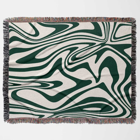 Forest green marble woven throw blanket for couch with green and white abstract pattern on a beige background