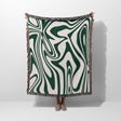 Forest green marble woven throw blanket for couch with green and white abstract marble pattern on a plain background