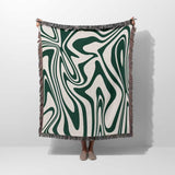 Forest green marble woven throw blanket for couch with green and white abstract marble pattern on a plain background