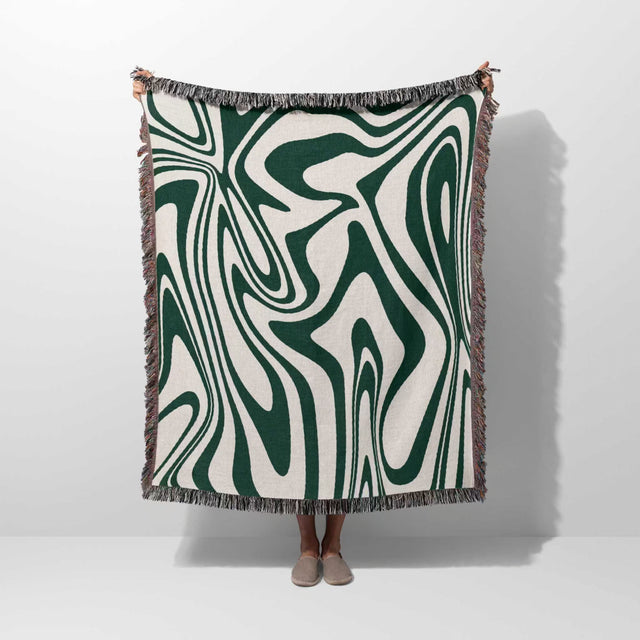 Forest green marble woven throw blanket for couch with green and white abstract marble pattern on a plain background