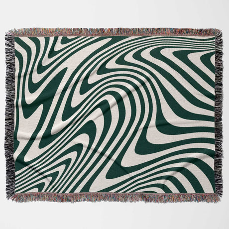 Forest green modern decorative woven throw blanket with green and white abstract pattern on a plain background