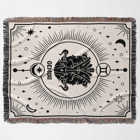 Flat horizontal image of Gemini Zodiac Blanket, displaying the intricate Gemini design with black and white pattern on an off-white background. The multicolor fringe adds a vibrant touch. Perfect as a thoughtful birthday gift idea for Gemini women and men, enhancing any home decor.