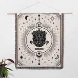 Gemini Zodiac Blanket hanging as wall art decor, displaying its artistic design with Gemini twins and celestial elements. The multicolor fringe and woven texture make it a versatile piece for home decor, perfect as a birthday gift for Gemini women and men who love zodiac-themed items.