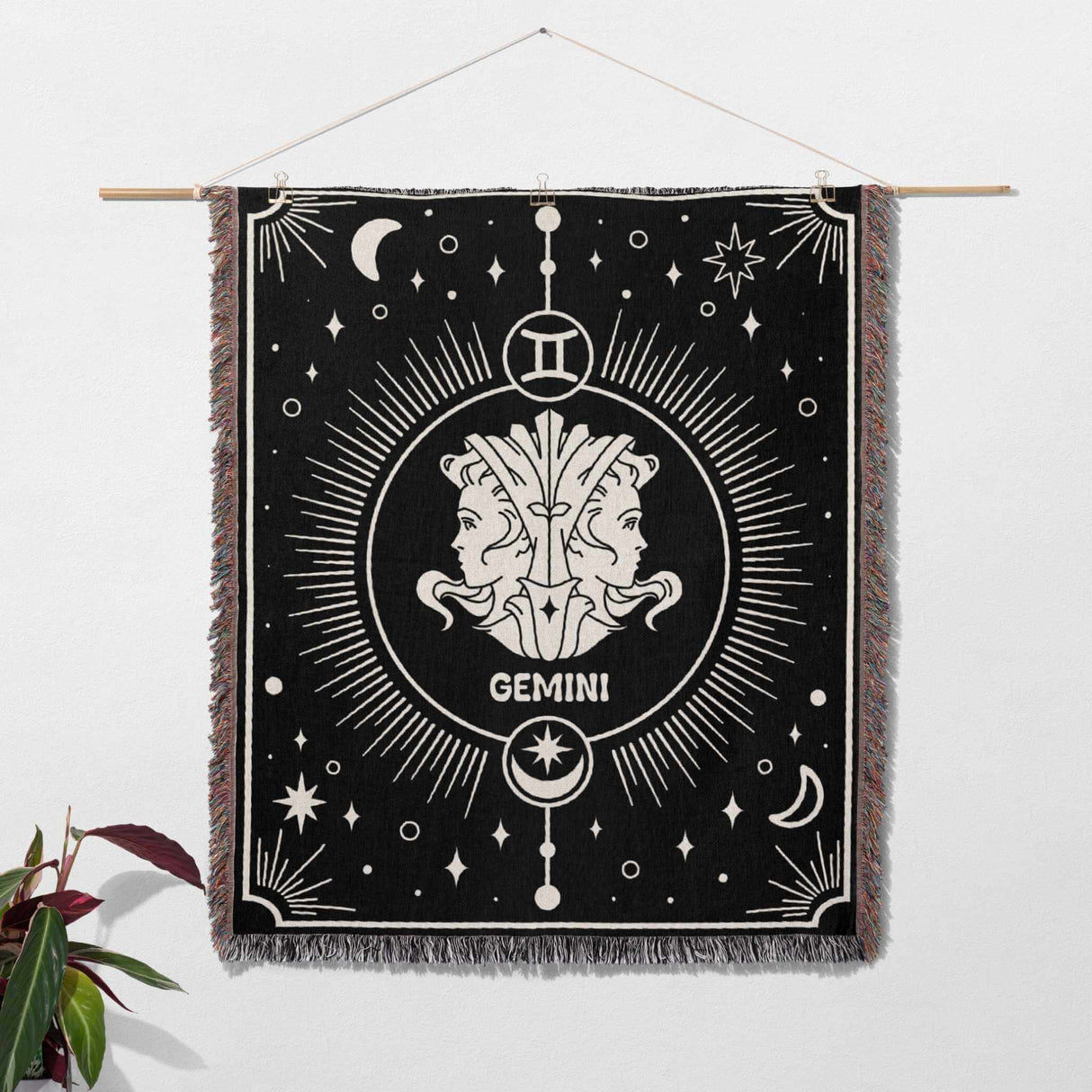 The Gemini Zodiac Blanket used as wall art decor, hanging on a wall. This image showcases the blanket's potential as a decorative tapestry, adding an astrological theme to the room's decor.