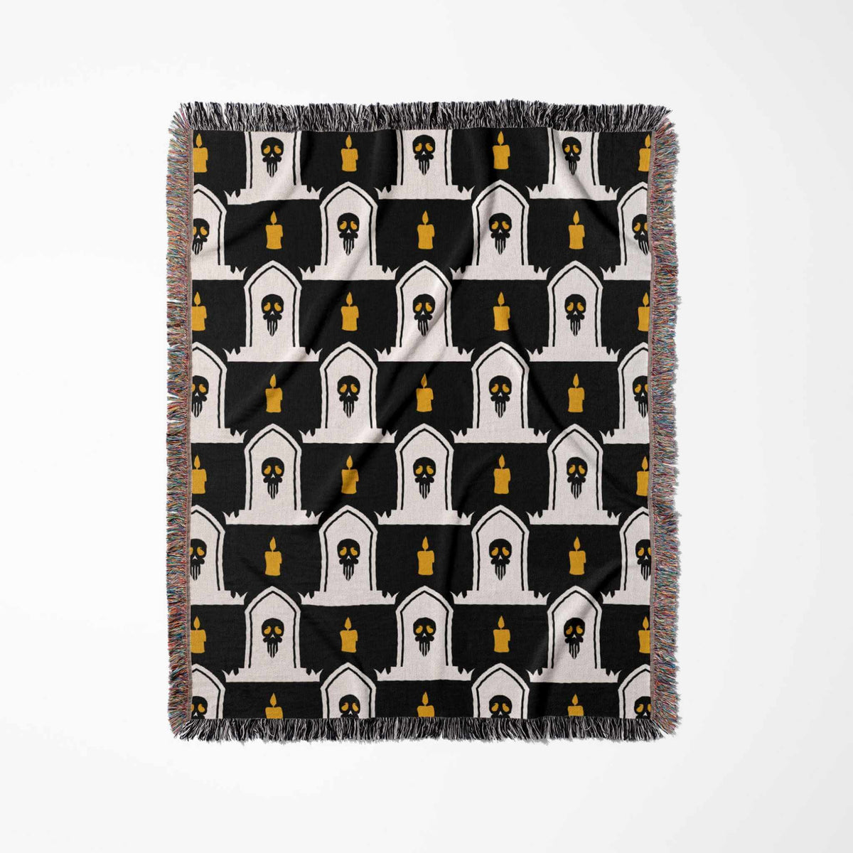Patterned throw blanket with black, white, and yellow design on a white background