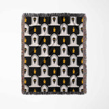 Patterned throw blanket with black, white, and yellow design on a white background