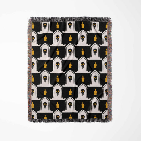 Patterned throw blanket with black, white, and yellow design on a white background