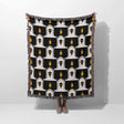 Black and white patterned throw blanket draped over a person on a white background
